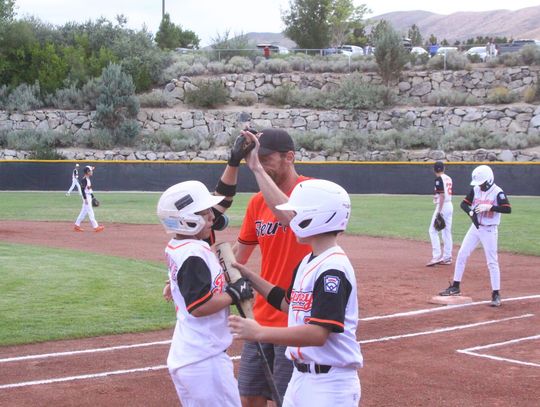Weston DeGolyer high fives a teammate after scoring a run during High  Desert Little League’s game against Carson Valley last Friday in the State Little League  Tournament in Reno. Photo by Robert Perea